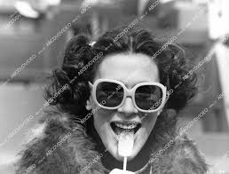 crp-07627 1980 Kaki Hunter in groovy sunglasses licking a lollipop film  Roadie crp-07627