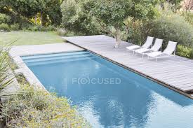 Shop the 23 best lounge chairs and chaises for your pool. Wooden Deck And Lounge Chairs By Swimming Pool Habitation Photography Stock Photo 199871492