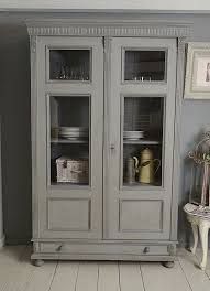 The silhouette linen cabinet offers a textured color palette for style and a large open compartment for storage, blending aesthetics and functionality. Large Shabby Chic Linen Cupboard Grey Vinterior
