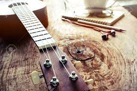 When you strum a ukulele, you're hearing a bunch of related vibrations: Close Up Of Ukulele On Old Wood Background With Soft Light Vintage Stock Photo Picture And Royalty Free Image Image 40926003