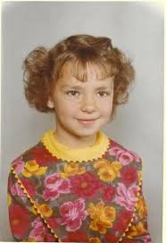 Because Ray had black curly hair, his mother couldn't bear to have it cut  until he started kindergarten at Woodlawn. He had just turned four when she  dressed him as a girl