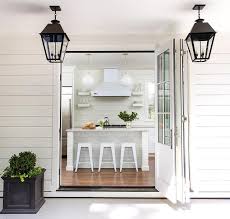 Large farmhouse open concept light wood floor, brown floor, vaulted ceiling and shiplap wall living room photo in charleston with white walls. Off White Shiplap Kitchen Walls Design Ideas