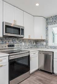 Farmhouse kitchen colors vary and will depend on your cabinetry, countertop, and rustic decor. White Cabinets With Colorful Backsplash Online Kitchen Cabinets Backsplash Kitchen White Cabinets Kitchen Backsplash