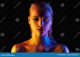 Rainbow Woman. Beautiful Girl in Color Lights Stock Photo