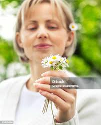 Beautiful Girl Enjoying Daisy Flower Stock Photo