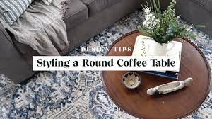 Start with large coffee table books or a tray (or both), and add a layer of texture. Design Tips Styling A Round Coffee Table Youtube