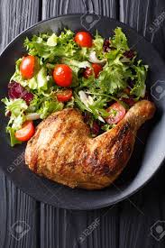 Turn off the burner and use tongs to take the parboiled chicken out of the liquid. Grilled Chicken Leg With Fresh Vegetable Salad Close Up On A Plate Vertical Top View From Above Stock Photo Picture And Royalty Free Image Image 96771368