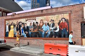 Everything is decked out in pink and white, from the scalloped umbrellas to the seating—even the flower beds are. Taylor Swift Removed From Country Legends Mural In Nashville