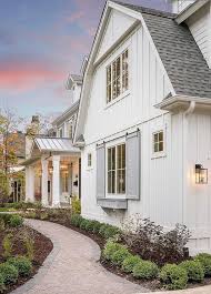 Vertical siding can be easier to maintain and clean, but it can be more expensive to install because firring strips need to be added behind the boards before they are nailed in. White Vertical Siding With Gray Shutters Combined Creates A Clean Fresh And Contemporary Fa Modern Farmhouse Exterior Farmhouse Exterior Exterior House Colors