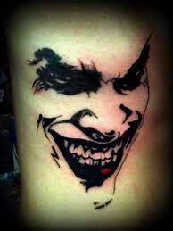 15 Best Joker Tattoo Designs And Meanings In 2021 Joker Tattoo Design Joker Face Tattoo Joker Tattoo