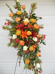Roses, hydrangeas, carnations, peony, lilies, orchids Masculine Orange Yellow Red And White Easel Spray By Petal People Florist
