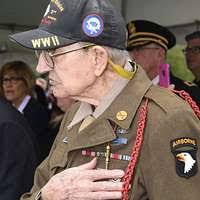 William H. Tucker, a veteran from the 82d Airborne (ABN) during the D-Day  Invasion signs his book, "Bill Tucker Parachuted Into History" for an  admirer in St Mere Eglise, France (FRA). Veterans