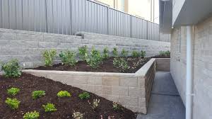 Petunias on the flower bed. Retaining Walls Newcastle Green Envy Landscaping