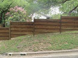 You can conquer the slope using one of two installation methods. Wood Fence On Slope Sloped Yard Wood Fence Yard Fence Ideas