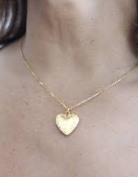 There is also a glass crystal heart that dangles beneath big ben. 11747 Gold Smallheart Locket Necklace Jane