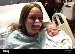 Jami Patterson shows off baby Grant, born at 12:12 P.M.