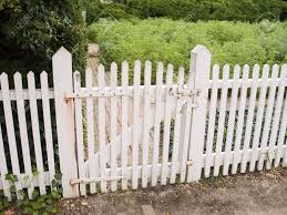 Closer to the home, topiaries and hanging baskets lend further color to the yard. An Old White Picket Fence And Garden Gate Stock Photo Picture And Royalty Free Image Image 747165