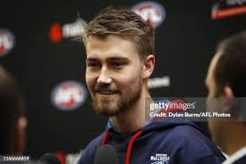 Kyle Dunkley of the Demons is seen with Ryan Gardner of the Bulldogs...  News Photo