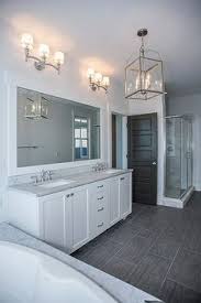 Feb 22, 2019 · a pure white bathroom with dark gray flooring (searl lamaster howe architects) floor tiles could be used on walls too, especially in a bathroom ( victoria vlasova interiors ) arabesque ombre grey floor tiles for bathroom floors Dark Grey Bathroom Tiles Ideas Trendecors