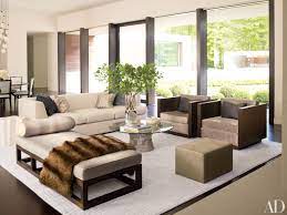 Today's post is about 3 ways to style a coffee table or ottoman. How To Incorporate Ottomans Into Your Living Room Decor Architectural Digest