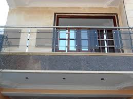 Striking modern entryway in white with clear glass stair railing. Modern Style Balcony Railing Modern Railing Design Exterior