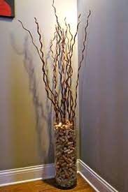 A natural outdoor fall arrangement of a large planter with pumpkins, gourds, blooms, cabbage and twigs and branches. 8 Best Vase With Sticks Ideas Vases Decor Floor Vase Decor Floor Vase