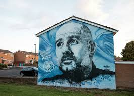 The new Pep Guardiola mural near the Etihad stadium was completed this  week. Sadly, just hours after it was unveiled, it was 'mindlessly  vandalised' with MUFC graffiti and black and white paint.