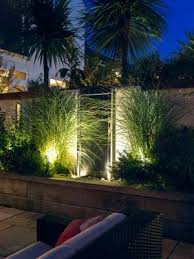 Portable outdoor lights (like a lantern or lamp) are an easy choice for outdoor areas without an outlet or nearby electricity. Modern Outdoor Lights Can Add Stunning Centerpieces To Yard Landscaping Or Highlight Your Beautiful Yard D Backyard Landscaping Front Yard Design Garden Layout