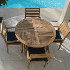 Avant 5 Piece Teak Patio Dining Set W 47 Inch Round Folding Table And Sunbrella Canvas Navy Cushions By Royal Teak Collection Bbqguys In 2020 Teak Outdoor Furniture Round Folding Table Teak Table