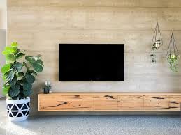 This tv stand provides abundant storage with cabinets and shelves in each. Timber Floating Tv Unit