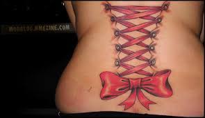A corset is a garment worn to hold and train the torso into a desired shape, traditionally a smaller waist or larger bottom, for aesthetic or medical purposes (either for the duration of wearing it or with a more lasting effect), or support the breasts. Corset Lacing Tattoo Bme Tattoo Piercing And Body Modification News