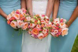 Think colorful collections of stems combining pink, coral, orange, ivory, and leafy greens—or choose another. Coral Rose Wedding Bouquet Wild Country Fine Arts