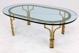 Vintage hollywood regency mastercraft italian brass gold faux bamboo glass coffee cocktail table genevasfinds 5 out of 5 stars (11) $ 950.00 free shipping add to favorites vintage hollywood regency faux bamboo end table glass top focusonfabulous 4.5 out of 5 stars (14. Lot Art Gilt Metal Faux Bamboo Oval Glass Cocktail Table 3 4 I