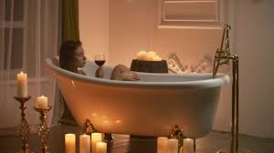 Young woman relaxing bathroom foam bathtub wine wrapped towel. Woman Lying In Bubble Bath With The Light From The Candles To Relax And Drink Wine Romantic Relaxing Aromatherapy Atmosphere Bathroom With Candles Video By C Petrunine Stock Footage 325107038