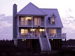 Builders raise a beach house as much as 15 feet or more above land level when constructing it on slopes or over the water. Parham Raised Coastal Home Plan 024d 0013 House Plans And More