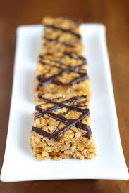 Heat the almond butter and maple syrup in the microwave for 30 seconds to one minute. Healthy Rice Krispie Treats Running With Spoons