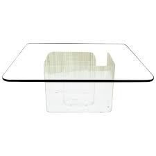 Playful little table in lucite and brass with three splayed tusk legs supporting a substantial chamfered glass top. Lucite Snail Base Square Thick Glass Top Coffee Table For Sale At 1stdibs