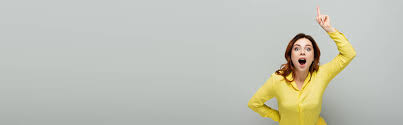 This high quality transparent png images is totally free on pngkit. Astonished Woman Pointing Up With Finger While Standing With Hand On Hip On Grey Banner Free Stock Photo And Image