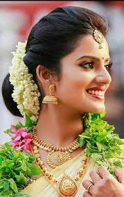 What A Beautiful Large Low Bun With Real Flower Gajra Care However Should Be Taken Before Adopting Such Hairs Bridal Hair Updo Hairdo Wedding Bridal Hair Buns