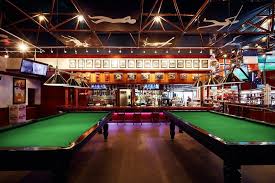 A game in which you use a stick to hit numbered balls into holes around a table, which is often played in bars. Champions Sports Bar Restaurant Bars Clubs Warsaw