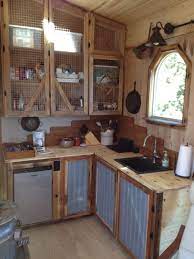 Use a bright white color scheme and smart positioning to create a less stuffy kitchen. Kevin S Tiny House Tiny House Kitchen Rustic Kitchen Cabinets Rustic Kitchen