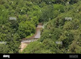 Dam on river in forest below the medieval hill town of Pitigliano, Tuscany,  Italy Stock Photo - Alamy