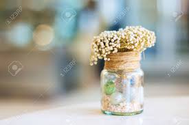 Welcome your guests by adding flowers to your bathroom or create a floral art piece in your living room. Dried Flowers In Glass Bottle On Wood Table Decorations In Cafe Selective Focus Stock Photo Picture And Royalty Free Image Image 74765411