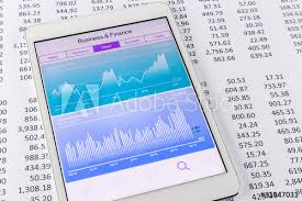 Stock Market Data And Financial Chart Or Graph On Tablet