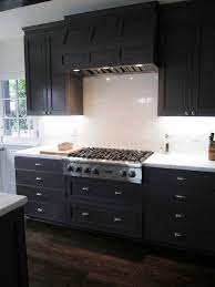Check out the brick kitchen island; Dark Kitchen Cabinets With White Marble Countertops Contemporary Kitchen Cococozy