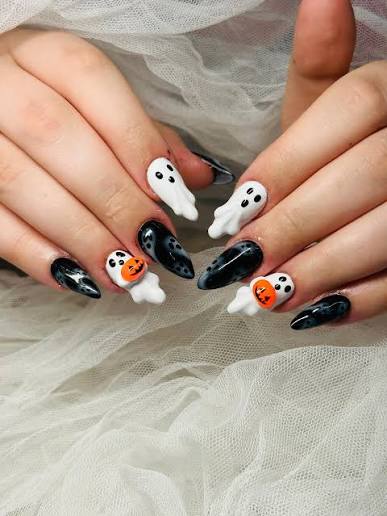 🎃 Spooky but cute! 👻🖤 These Halloween nails are giving all the right  vibes — a mix of spooky and sweet! Perfect for the season — little ghosts  and pumpkins to keep