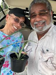 Audrey Mackey and I are smiling for the bounty of Saturday's Meet & Greet  courtesy of Denise R. Jacobs, Angela Yvette, and Catherine Marco,,, coveted  Antigua Black pineapple plants, a plantain and