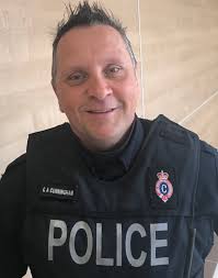 Duck family safely crosses highway after police officer stops traffic