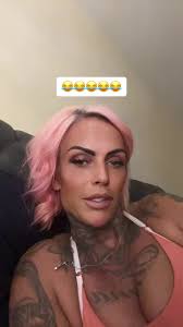 Person with Pink Hair and Tattoos in Unique Style