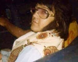 Elvis wearing his glasses while